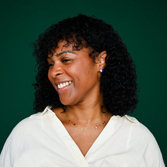 Picture of a woman wearing 14k gold plated studs, studs with resin, gold earrings, fair trade jewelry, quality jewelry