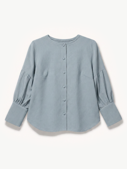 A dusty blue long-sleeve blouse with a button-up front, crew neck, and gathered puff sleeves, shown flat on a light cream background.