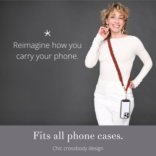 Woman wearing Wear Hope terra cotta strap crossbody with a phone, with Fits All Phone Cases text