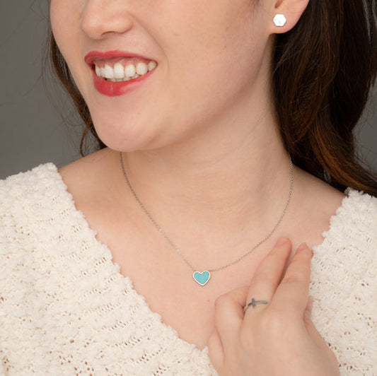 Woman wearing silver and blue heart necklace, heart shaped jewelry, women's silver and blue marble heart jewelry
