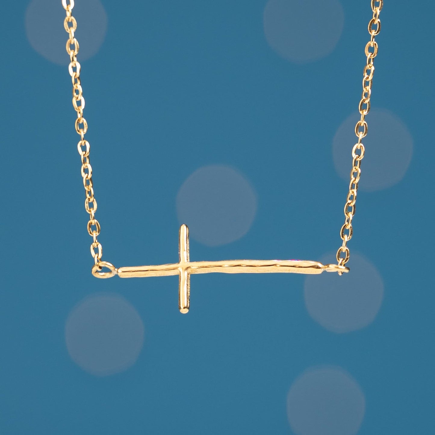Close up photo of gold cross pendant, surprises for Christmas, gift shops near me, fair trade artisan jewelry