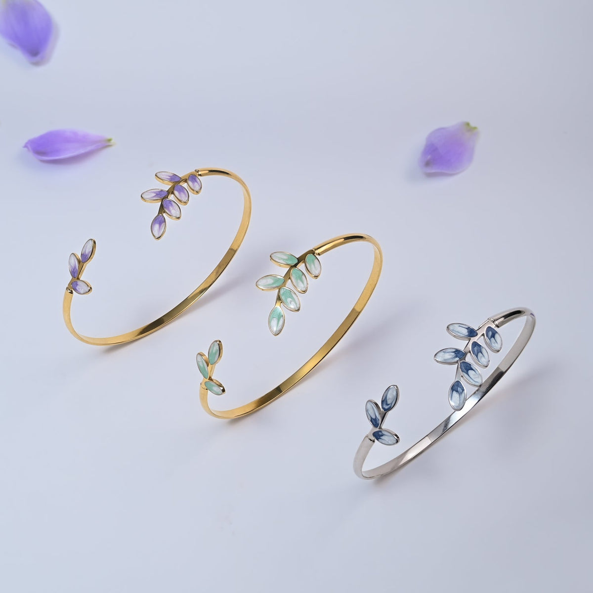 Three Hope Grows leaf cuffs in lavender, mint and silver-blue among purple petals