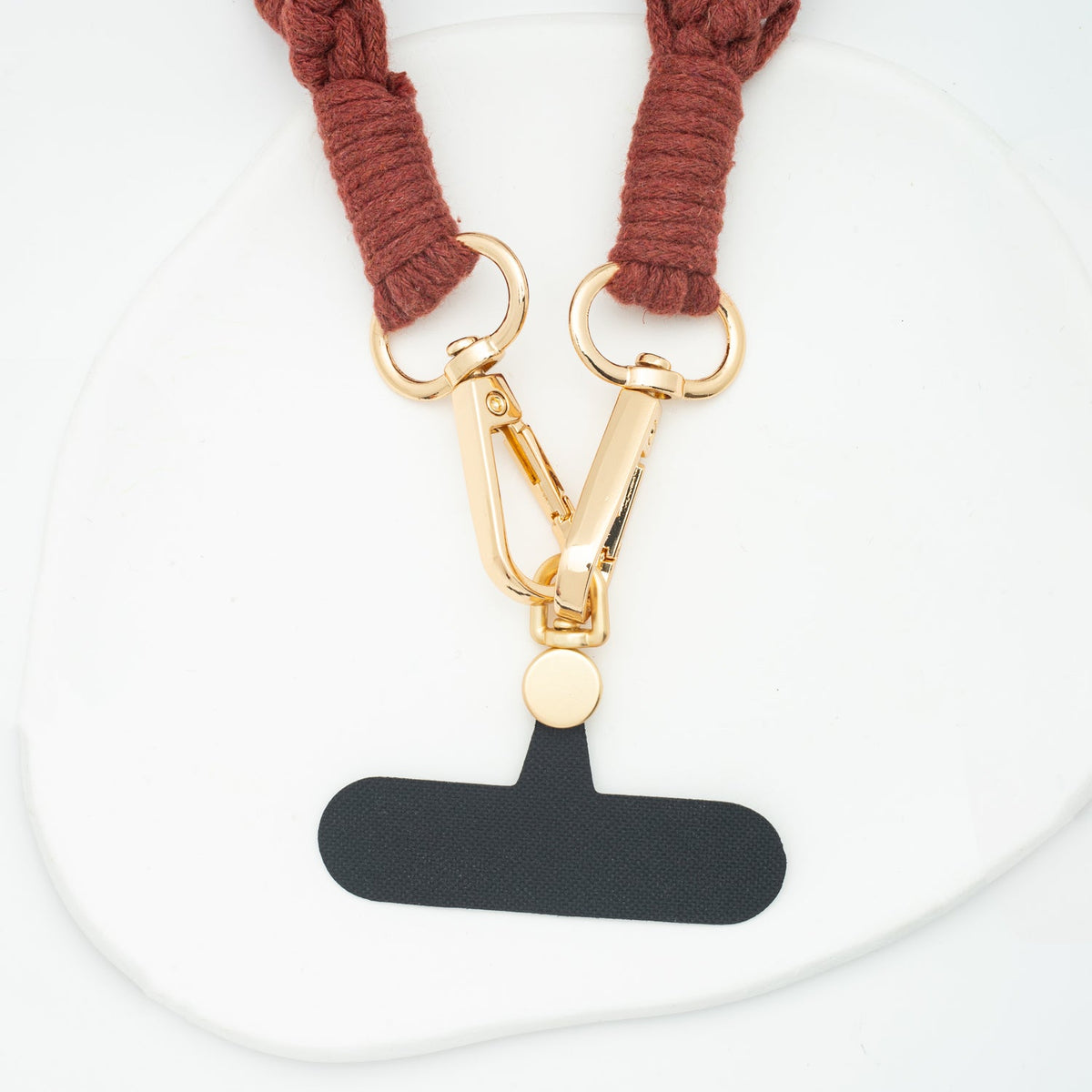 Wear Hope terra cotta strap clasps attached to a phone tether