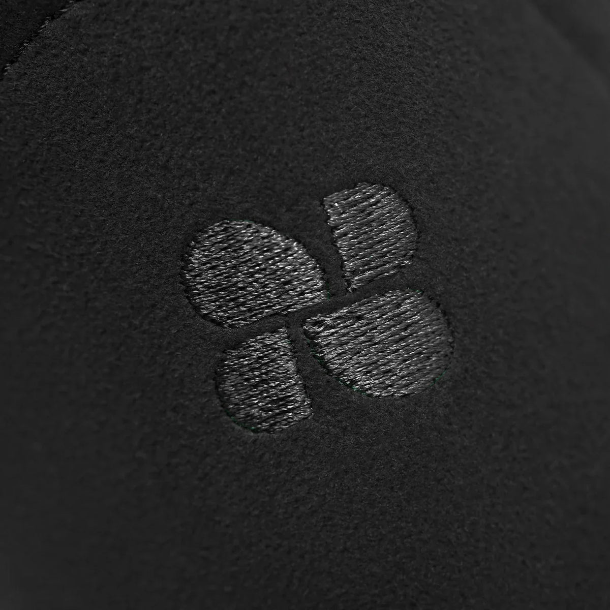Close-up of a textured logo on a black background