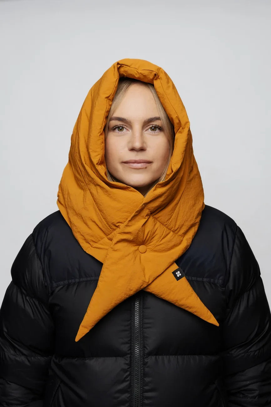 Amber yellow vegan winter capuche made from recycled materials, worn over black puffer jacket. - The New Orchard - Amber Yellow