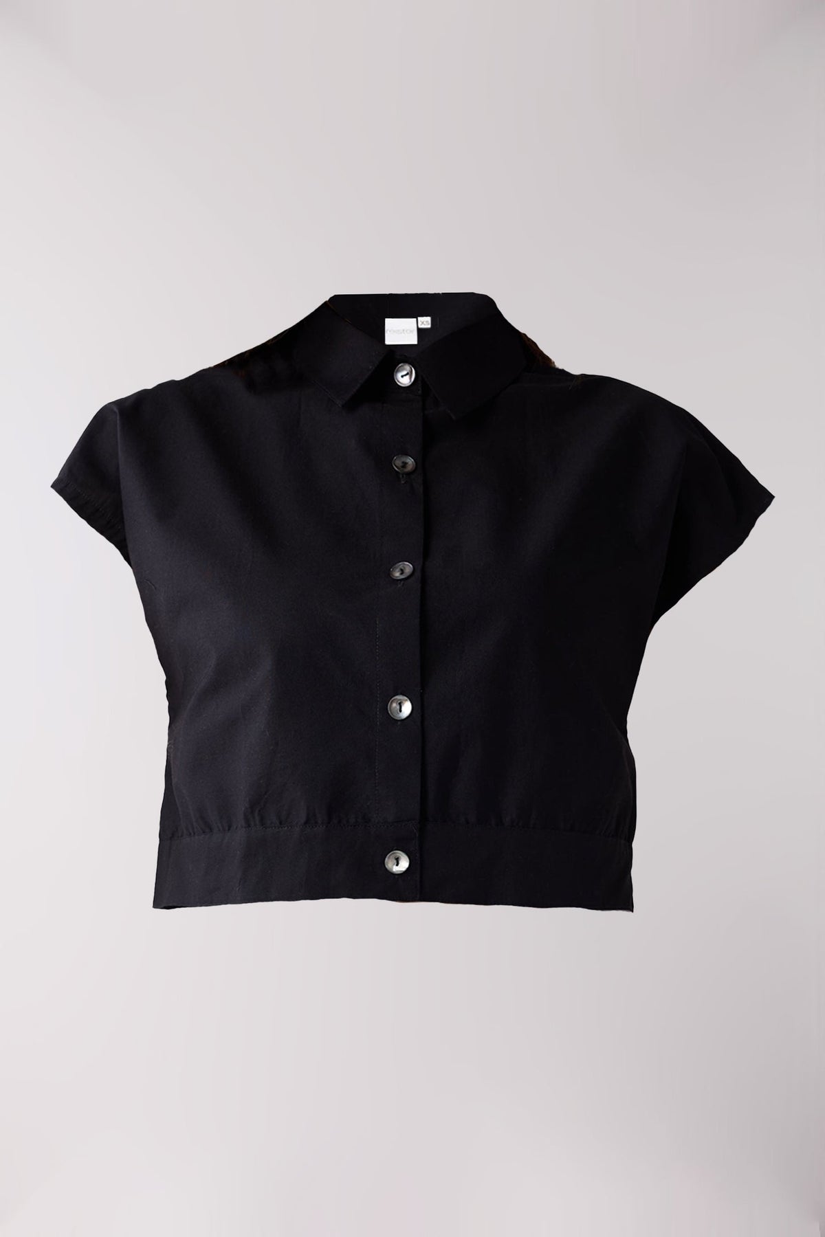 Black short-sleeve blouse with buttons on a light gray background
