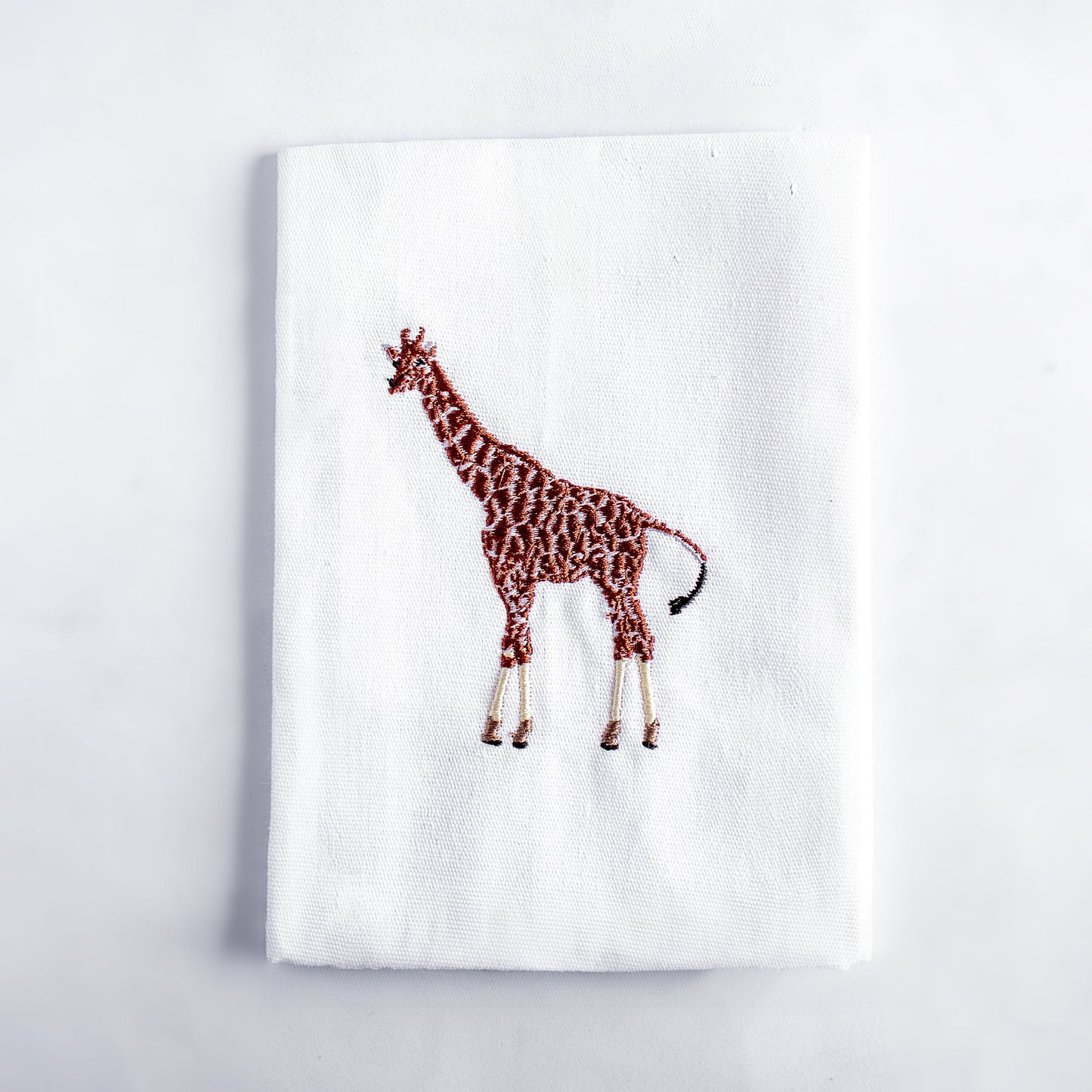 Giraffe embroidered cotton cloth napkin on white background