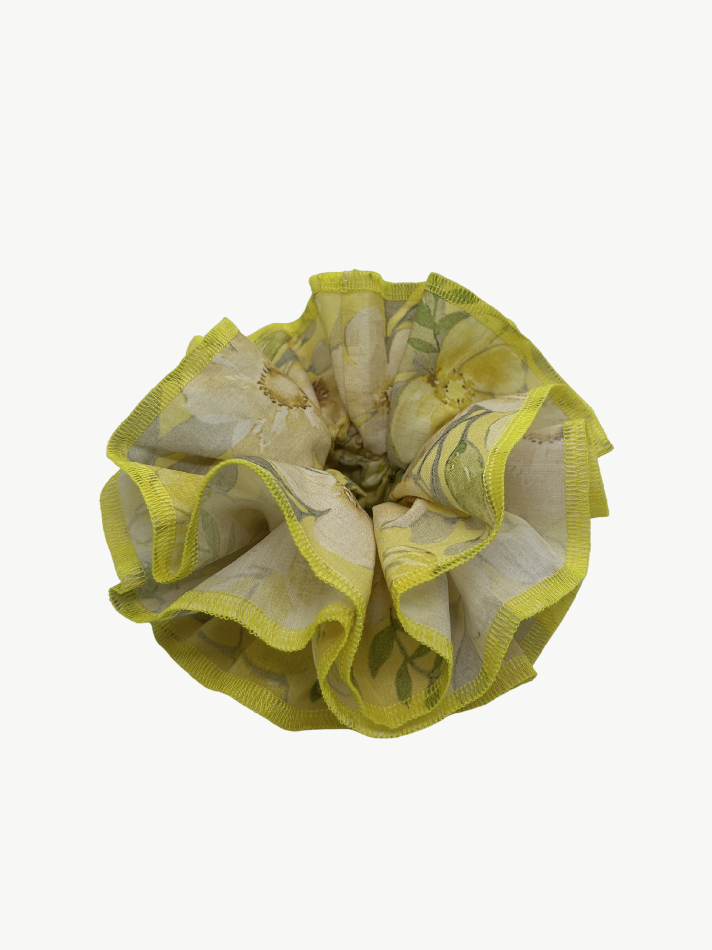 Yellow floral hair scrunchie on a white background