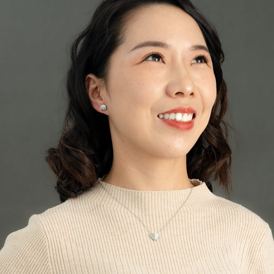 Woman wearing silver heart necklace, heart shaped jewelry, women's silver and marble heart jewelry