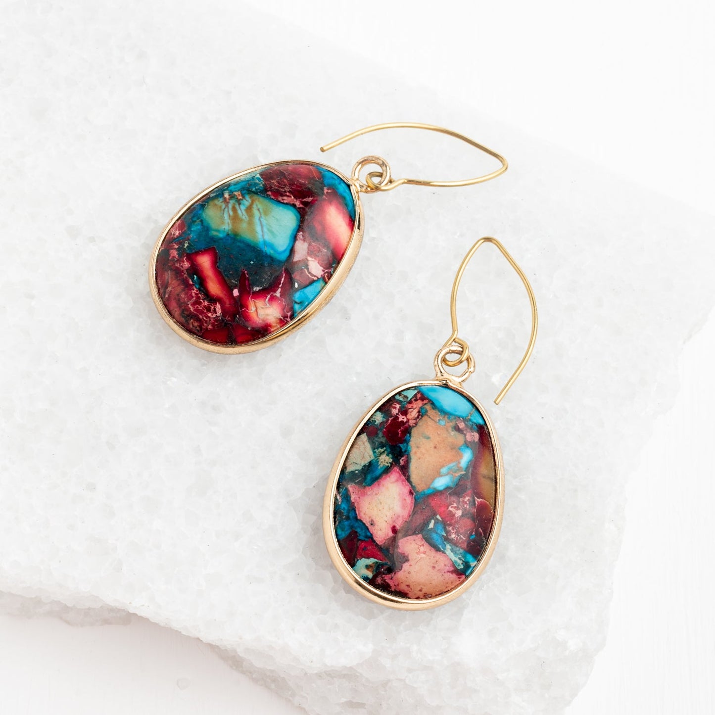 A beautiful pair of earrings placed on a crystal platform, jasper earrings with 14k gold plated earring posts, colorful fashion women's jewelry, adult jewelry