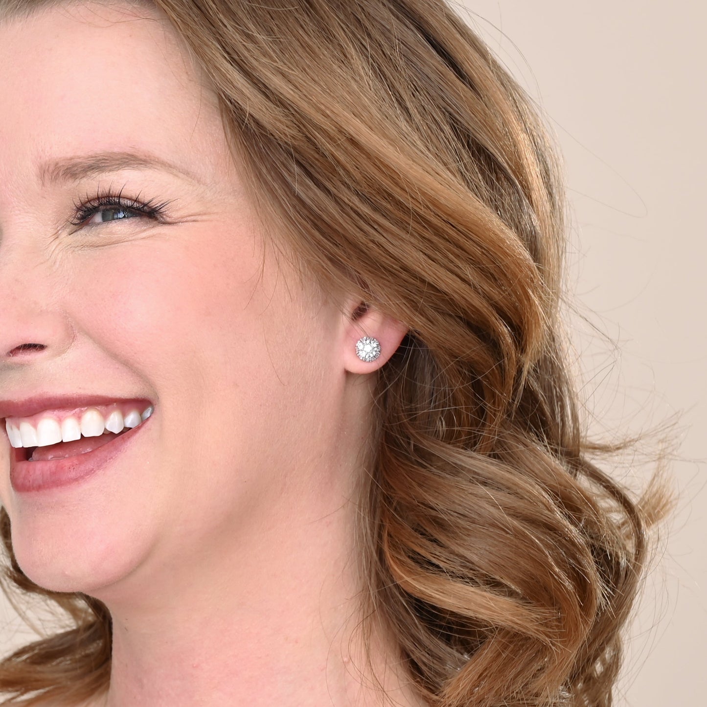 A woman wearing shiny, quality, silver studs, silver wedding day studs, high end silver earrings