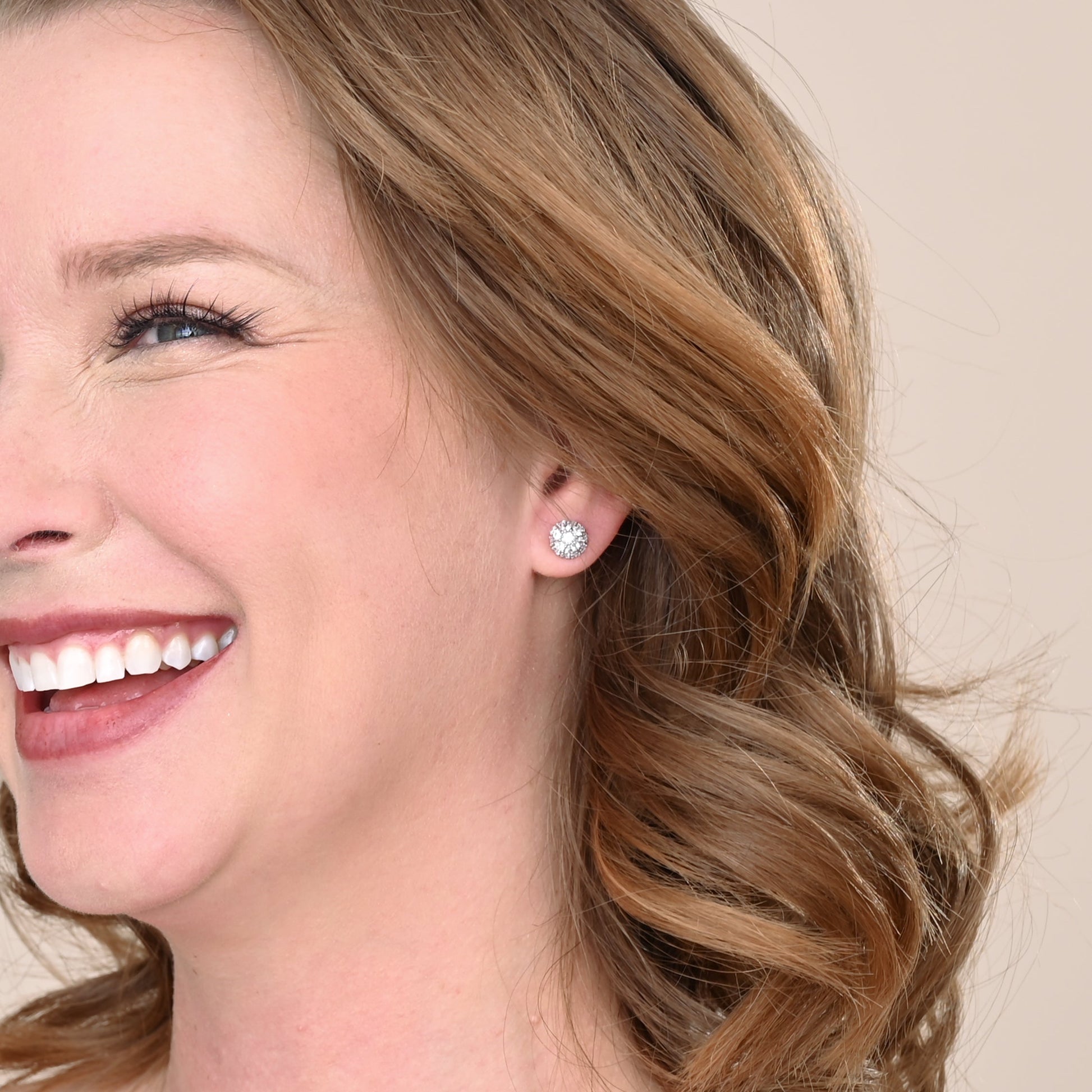 A woman wearing shiny, quality, silver studs, silver wedding day studs, high end silver earrings