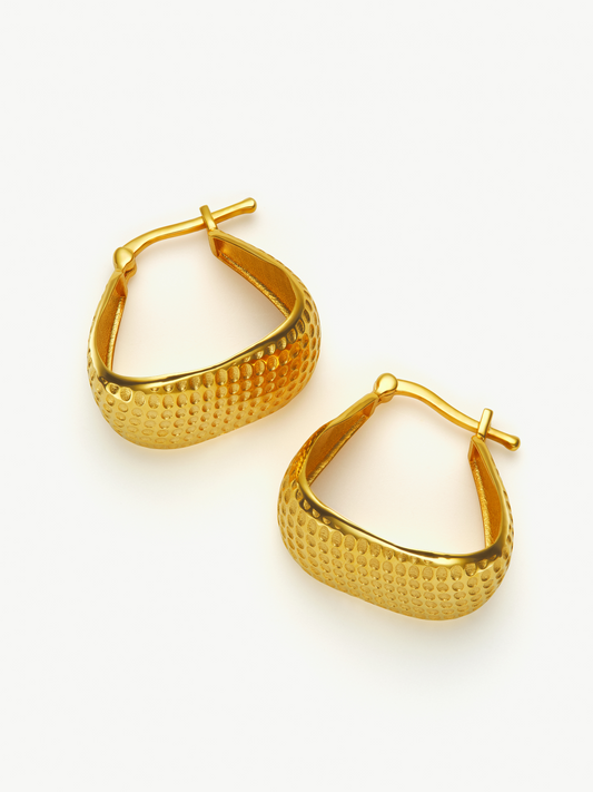 Pair of gold hoop earrings on a white background