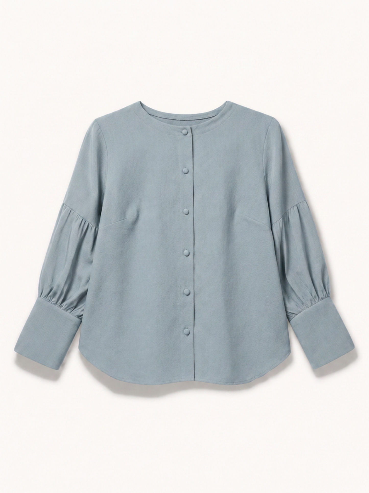 A dusty blue long-sleeve blouse with a button-up front, crew neck, and gathered puff sleeves, shown flat on a light cream background.