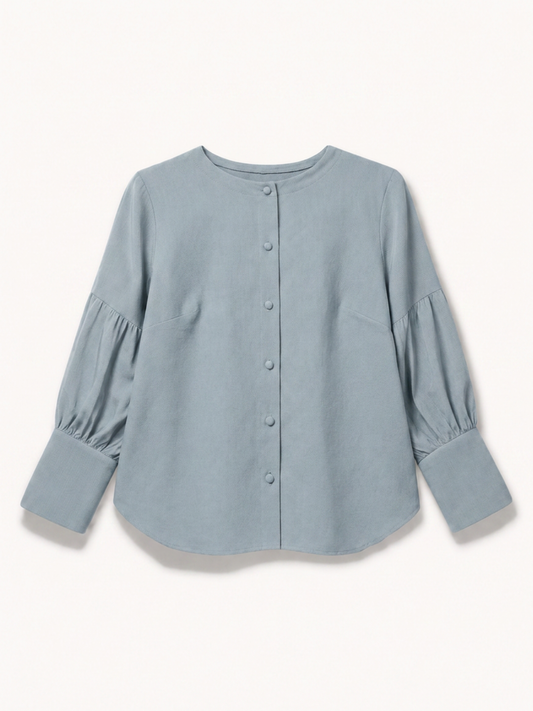 A dusty blue long-sleeve blouse with a button-up front, crew neck, and gathered puff sleeves, shown flat on a light cream background.
