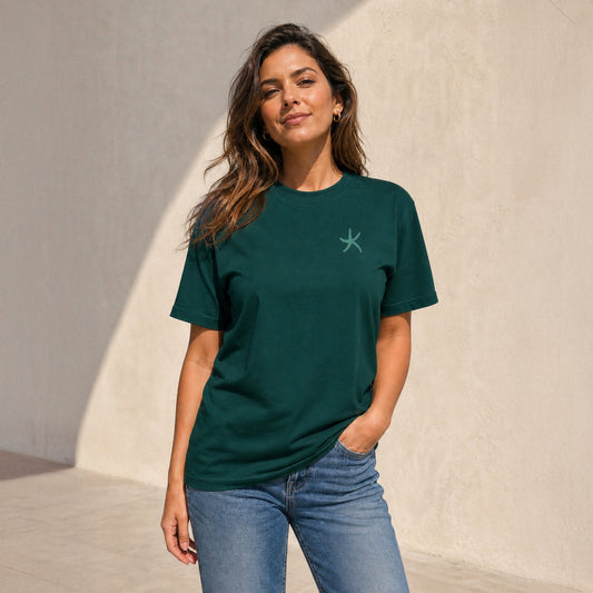 Smiling woman in dark green Wear Hope T-shirt with teal starfish logo