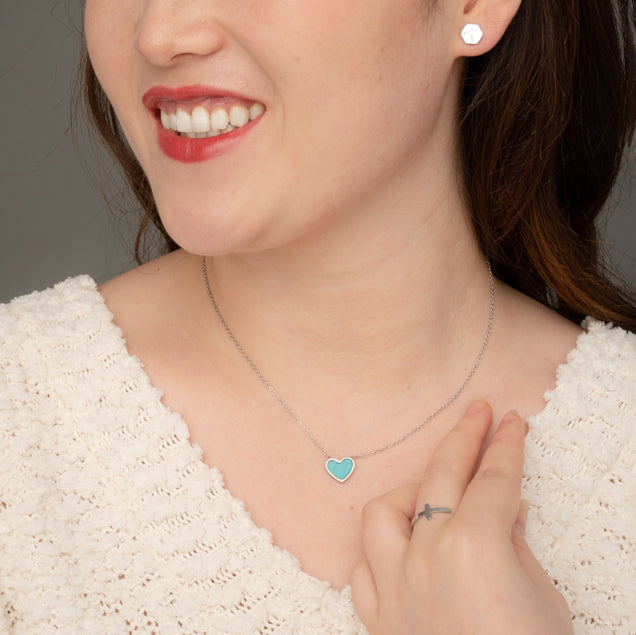 Woman wearing silver and blue heart necklace, heart shaped jewelry, women's silver and blue marble heart jewelry