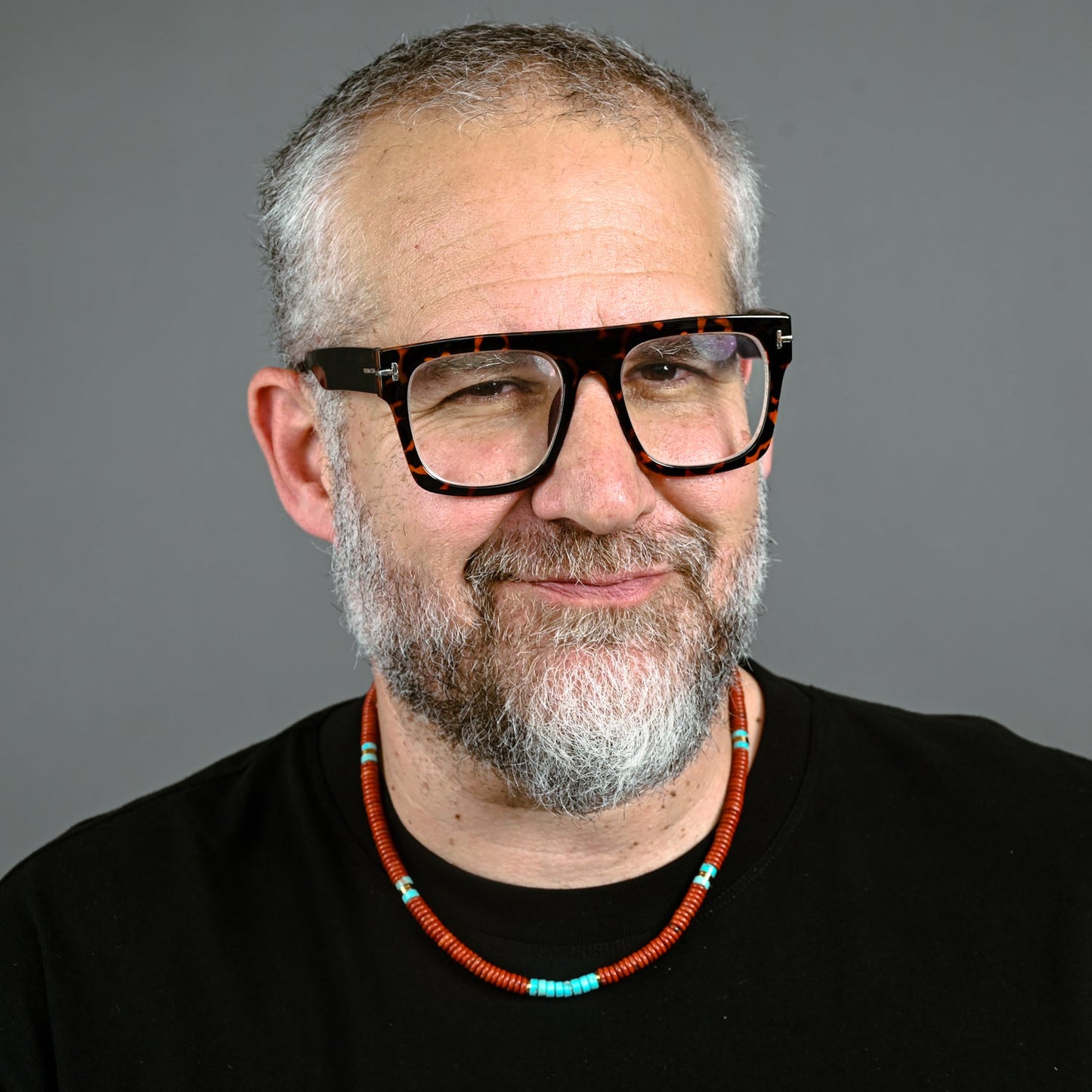 A man modeling red and turquoise necklace, freedom business, online jewelry shopping