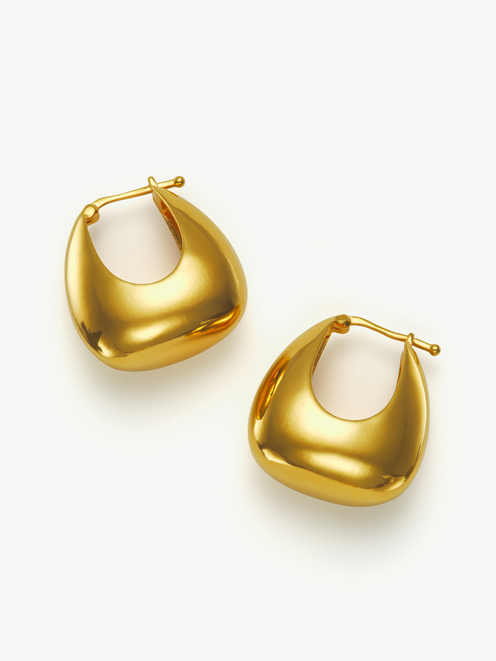 Pair of gold hoop earrings on a white background
