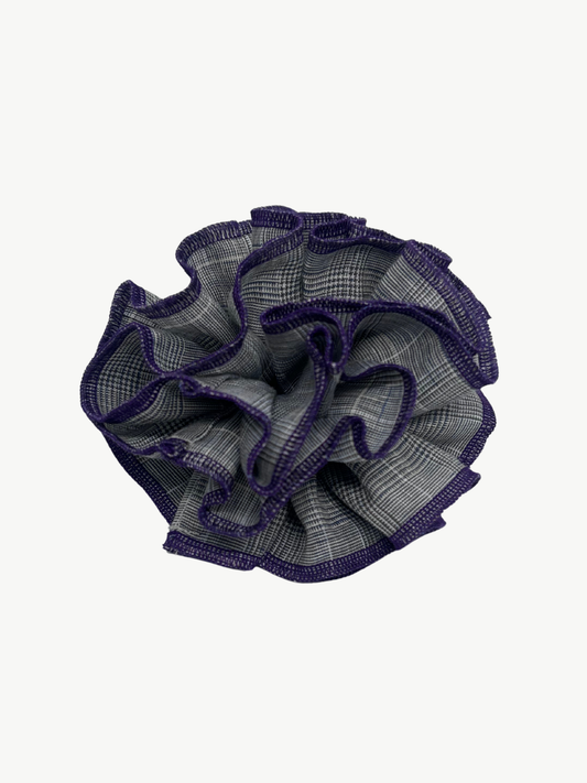Textured purple and gray scrunchie on a white background