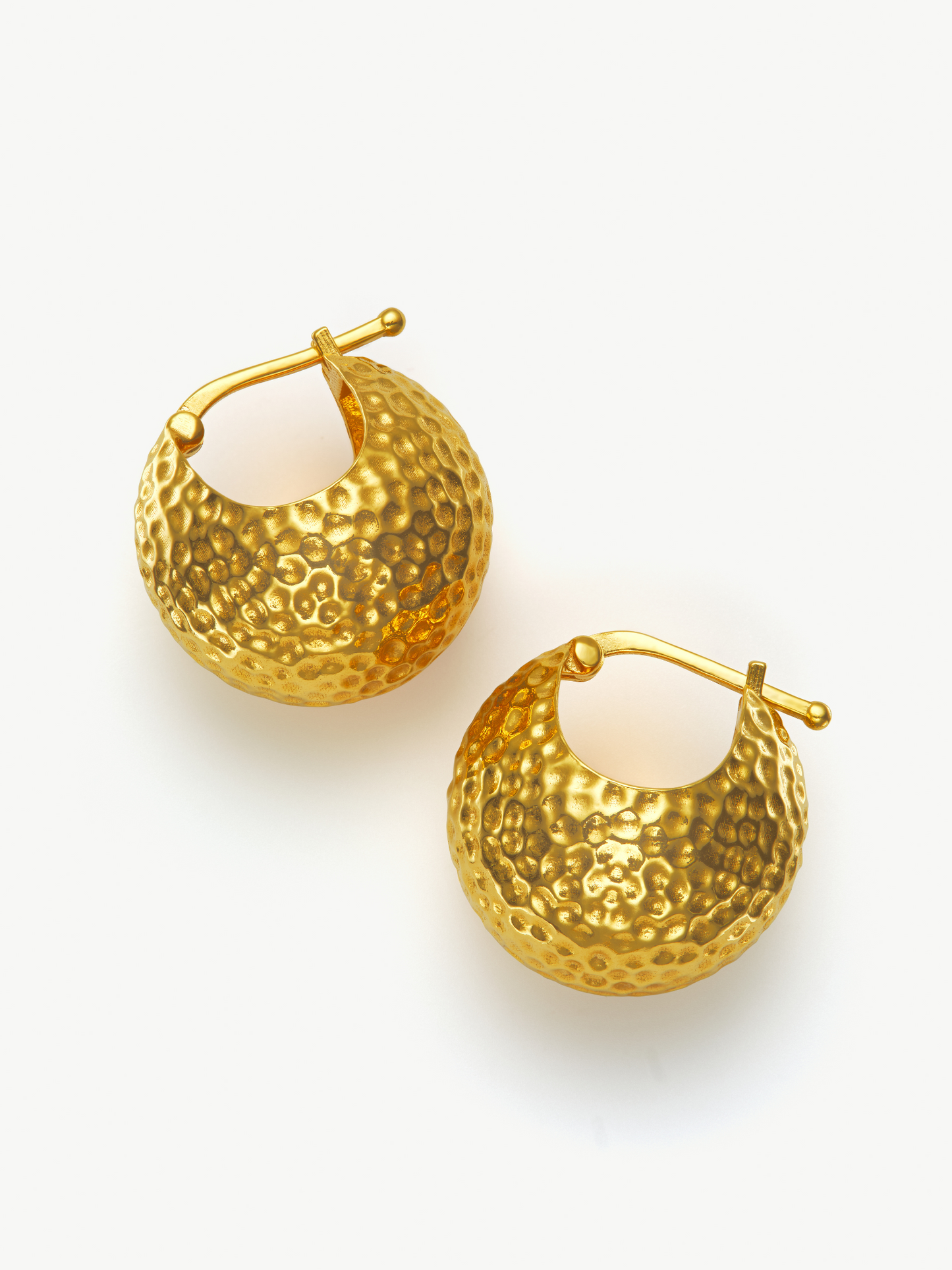 Gold hoop ball earrings on a white background