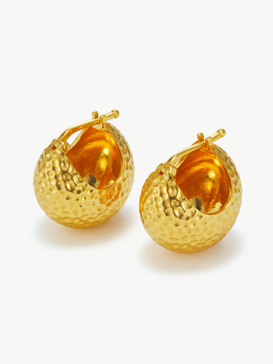 Pair of gold ball hoop earrings on a white background