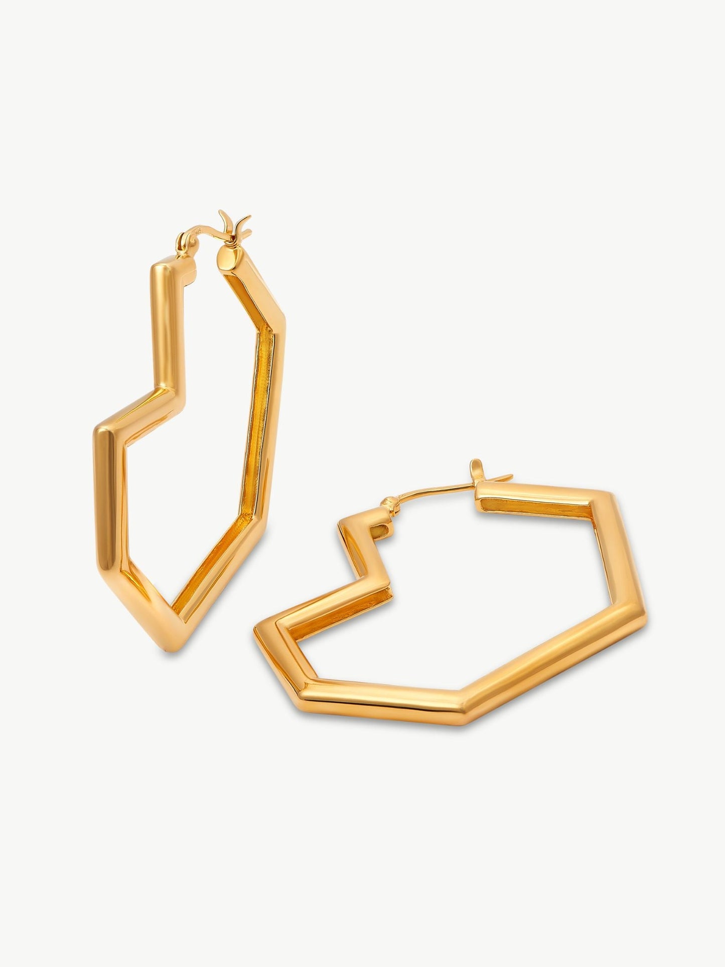 Gold heart hoop earrings on a white background