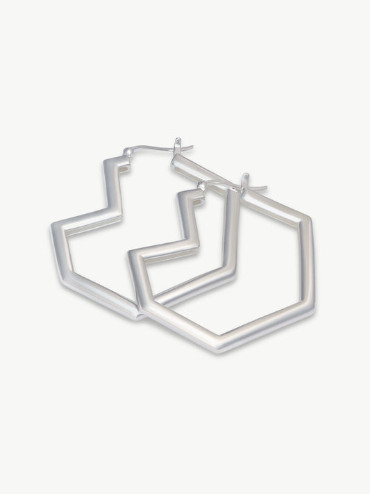 Set of silver heart hoop earrings on a white background