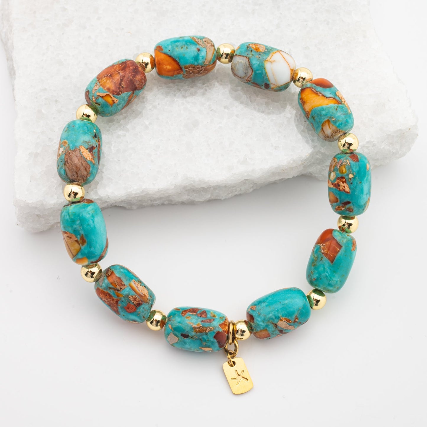 Photo of emperor stone bracelet, colorful  blue, orange, and white stones, gold starfish logo, jewelry gift store, womens bracelet