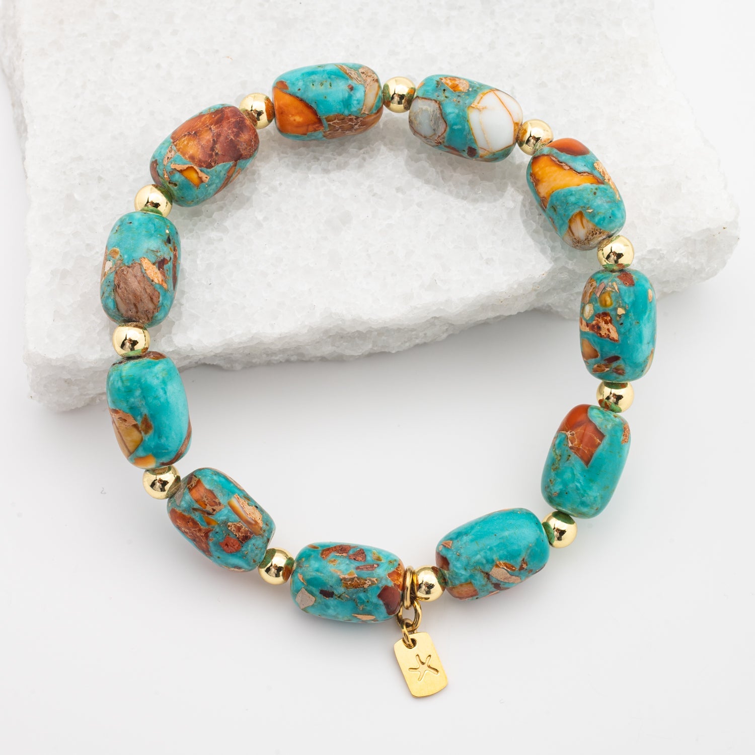 Photo of emperor stone bracelet, colorful  blue, orange, and white stones, gold starfish logo, jewelry gift store, womens bracelet