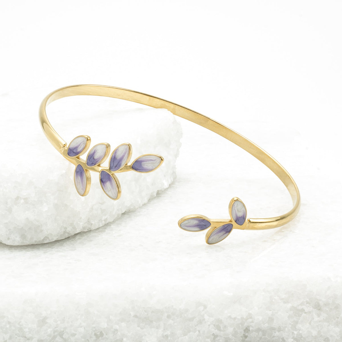Hope Grows gold cuff with lavender enamel leaves on white stone