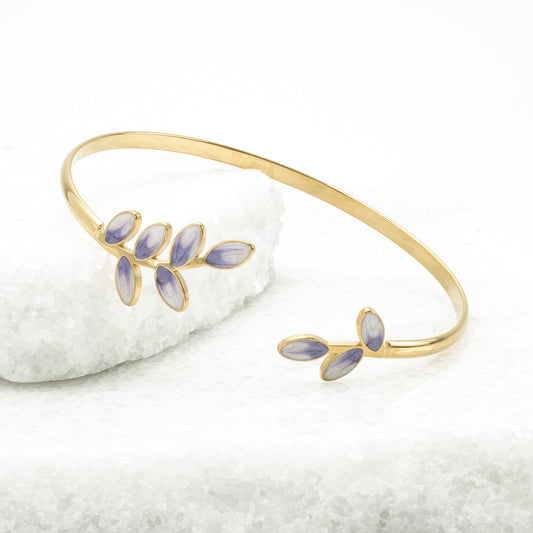 Hope Grows gold cuff with lavender enamel leaves on white stone