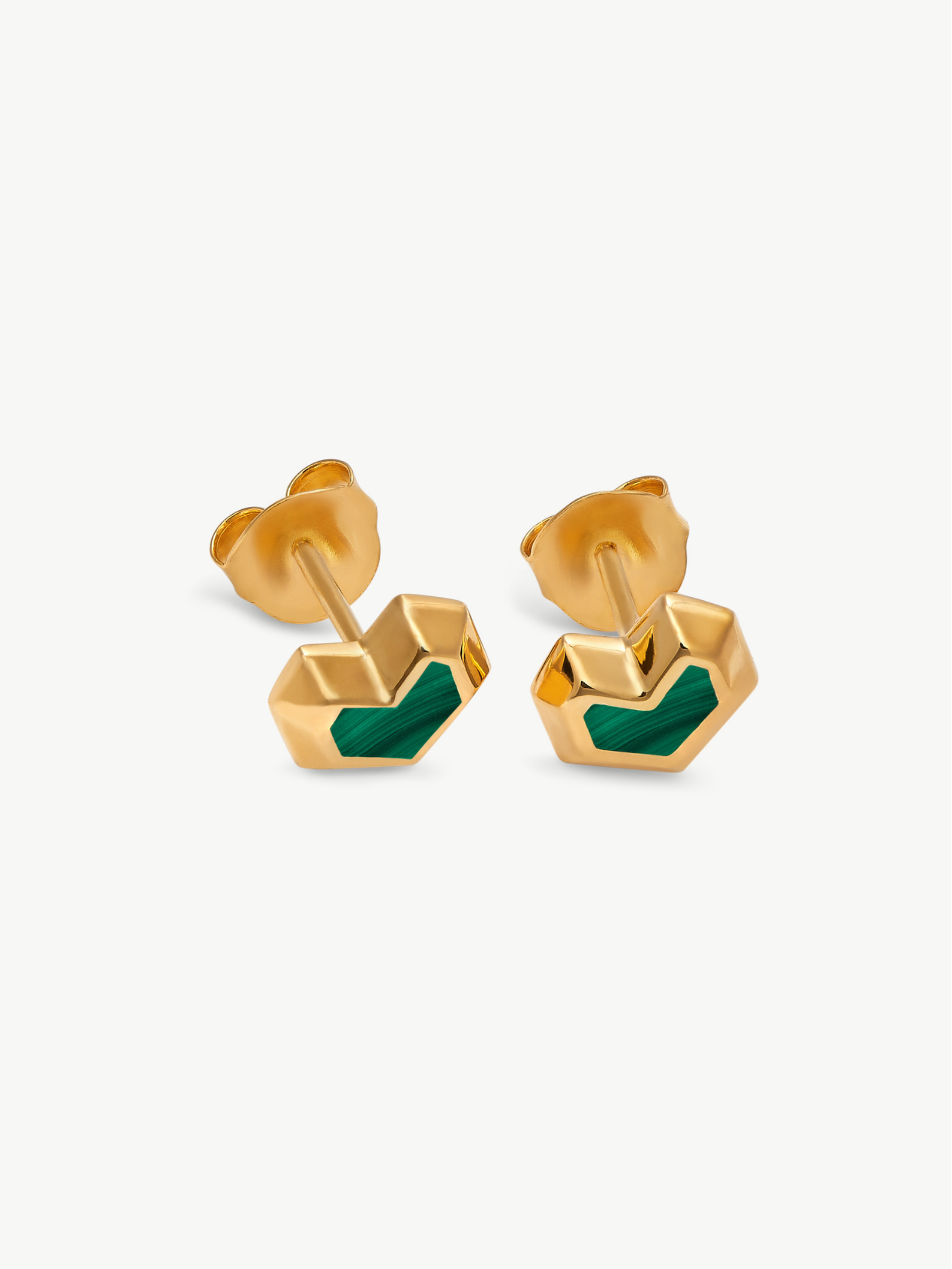 Gold earrings with green stone on a white background