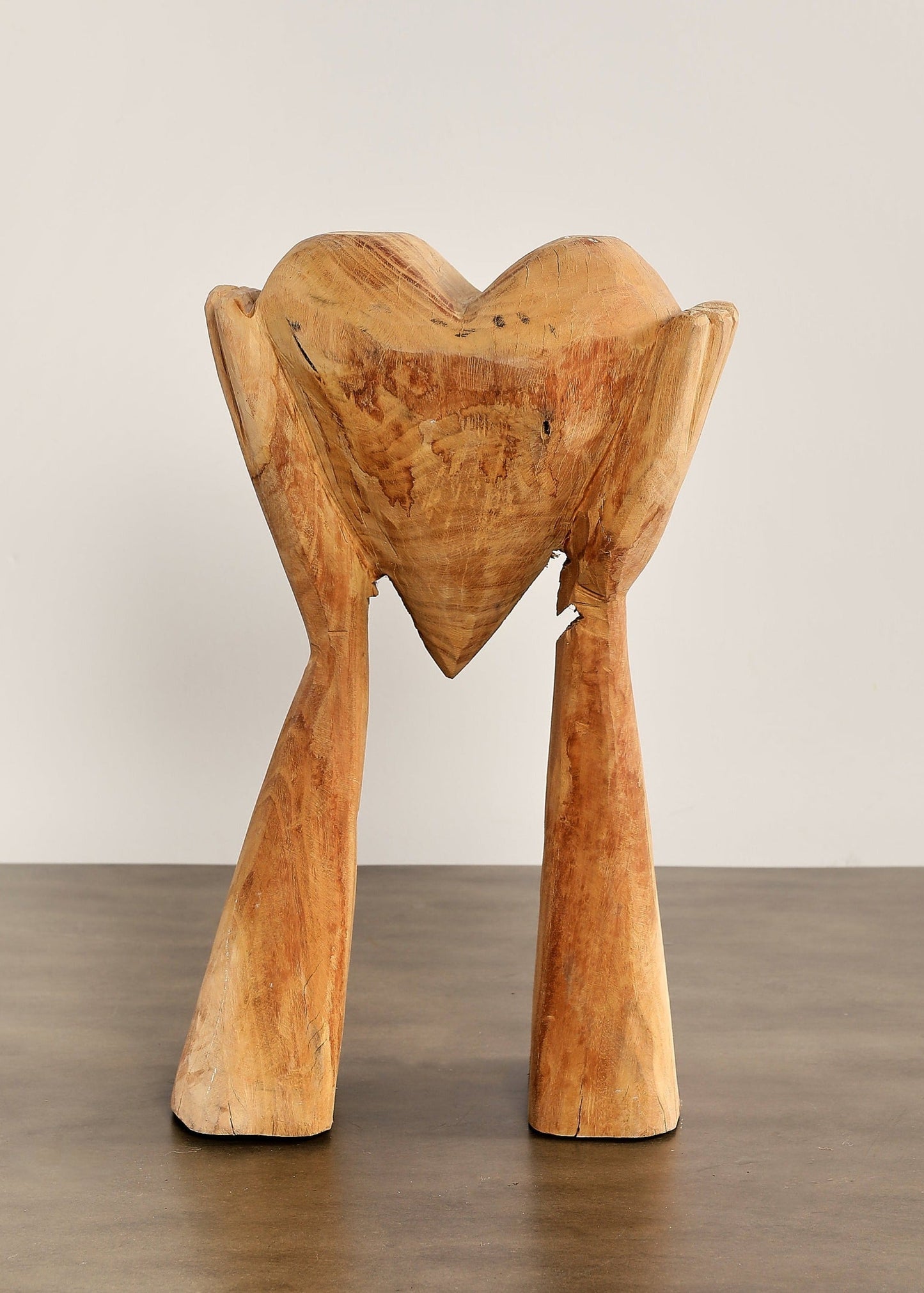 Hands Holding Heart Sculpture
