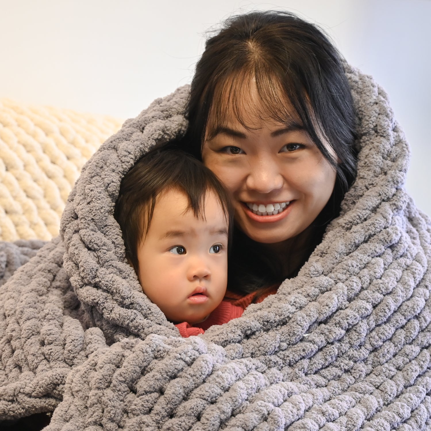 A photo of a mother and daughter in beautifully hand made blanket, special mother's day present