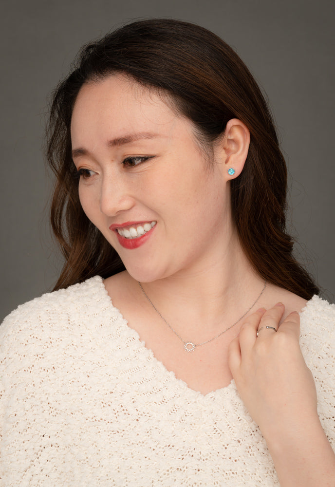 A woman wearing quality silver necklace with silver stud earrings, holiday gift ideas, freedom business