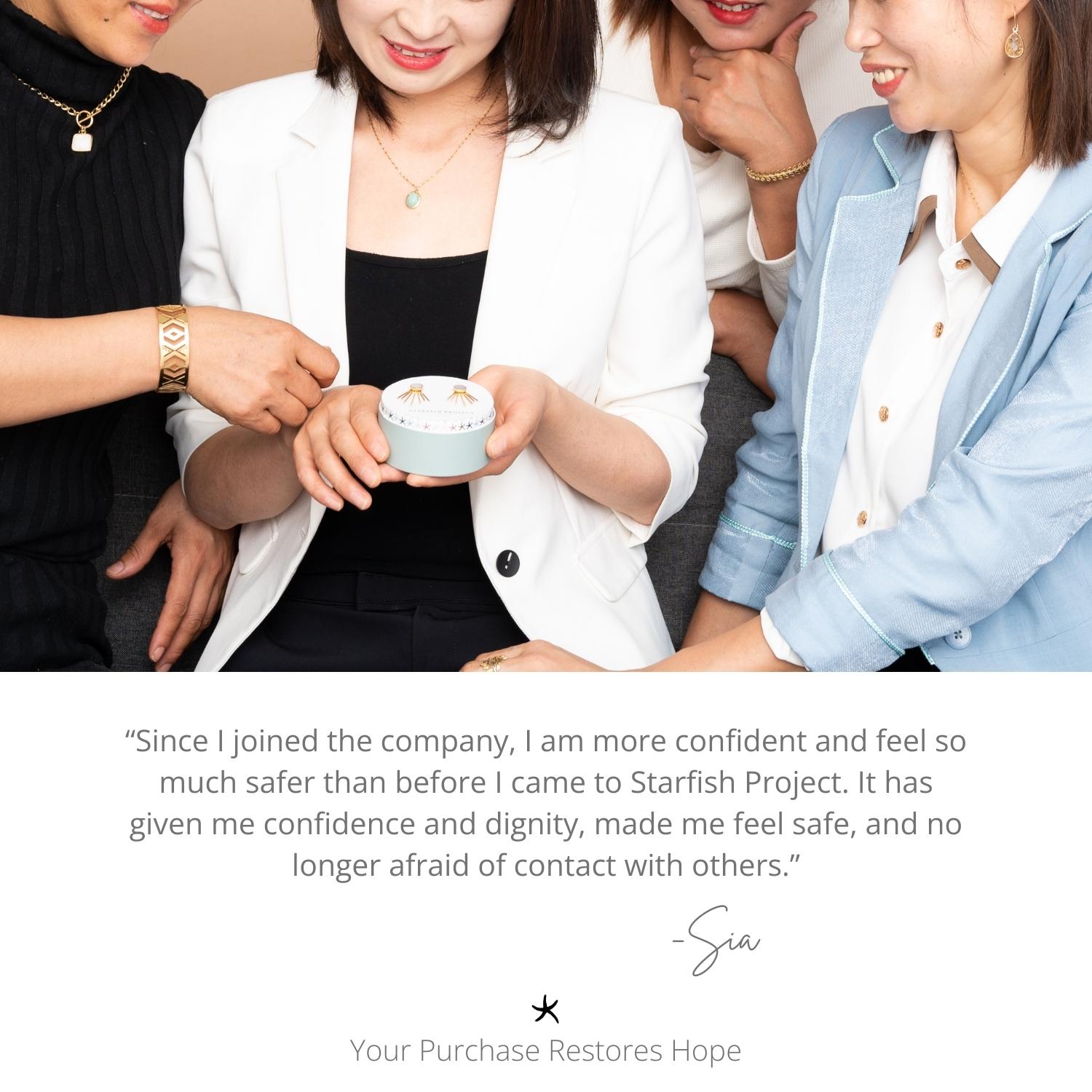 Group of people gathered around a small container, Ideas for a Christmas present, with a quote about confidence and safety from Starfish Project. Women’s artisan jewelry