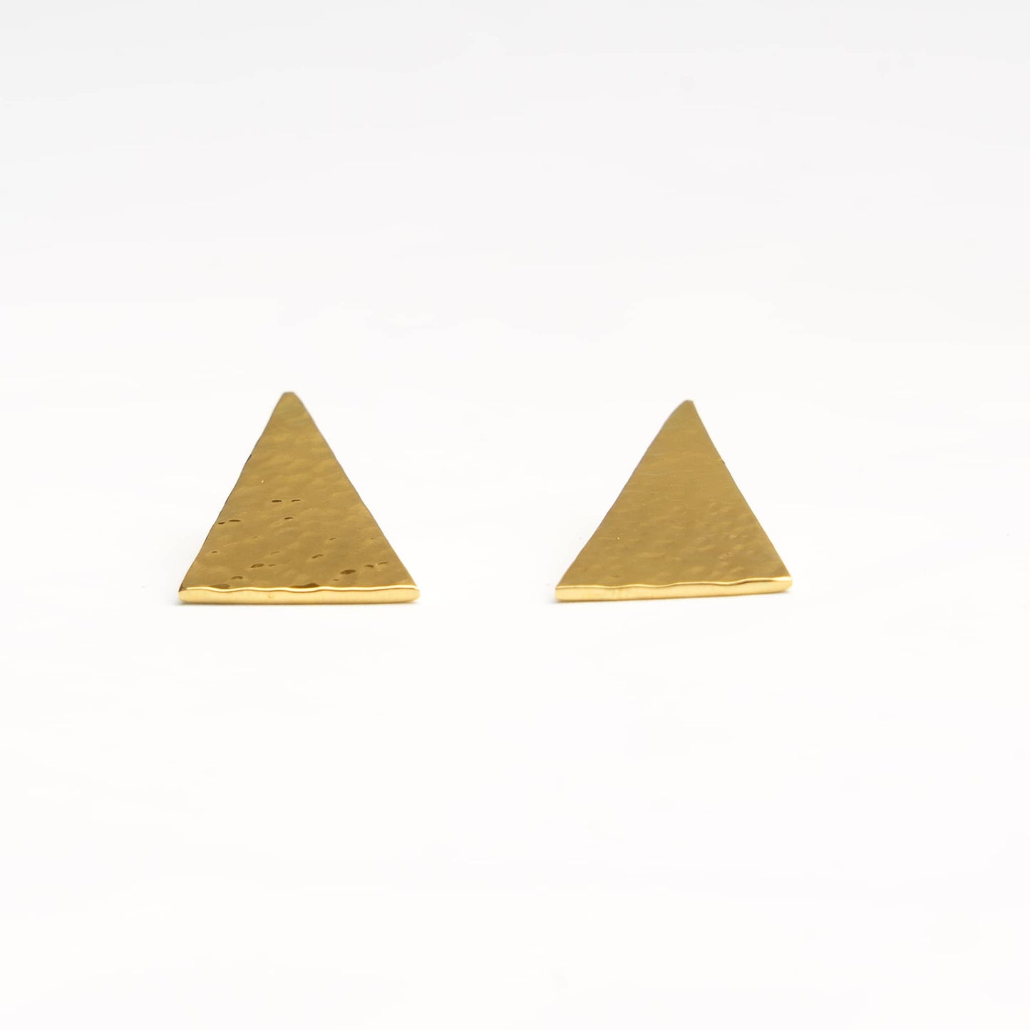 Amali brass hammered triangle stud earrings worn on ear