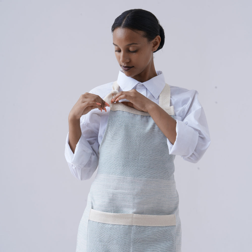 Apron in azurro on ethiopian model with white background