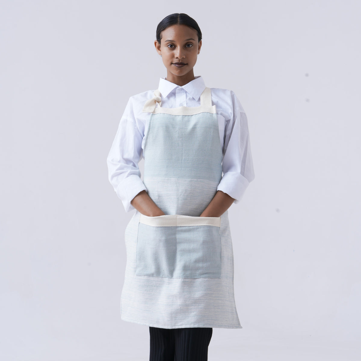 Azurro Apron on Ethiopian Model Facing Forward on White Background