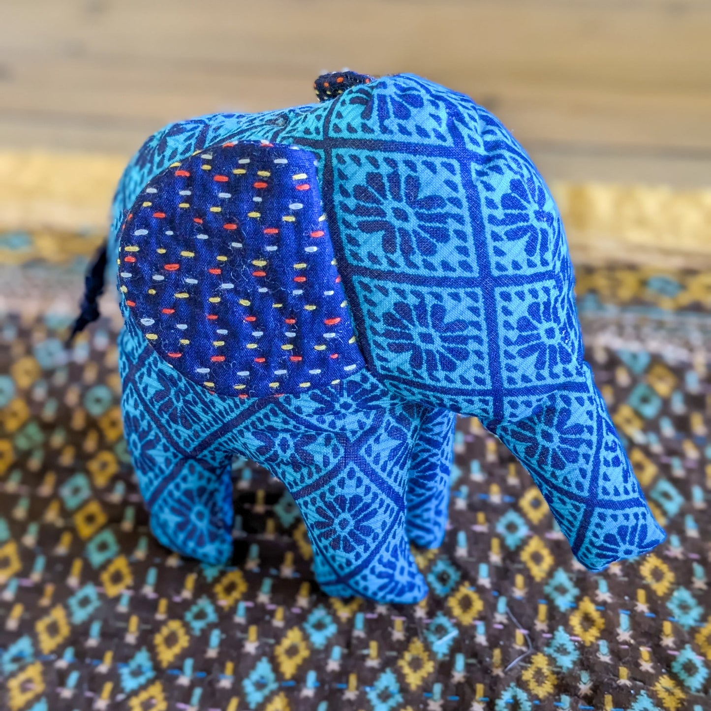 Blue patterned elephant on a textured surface