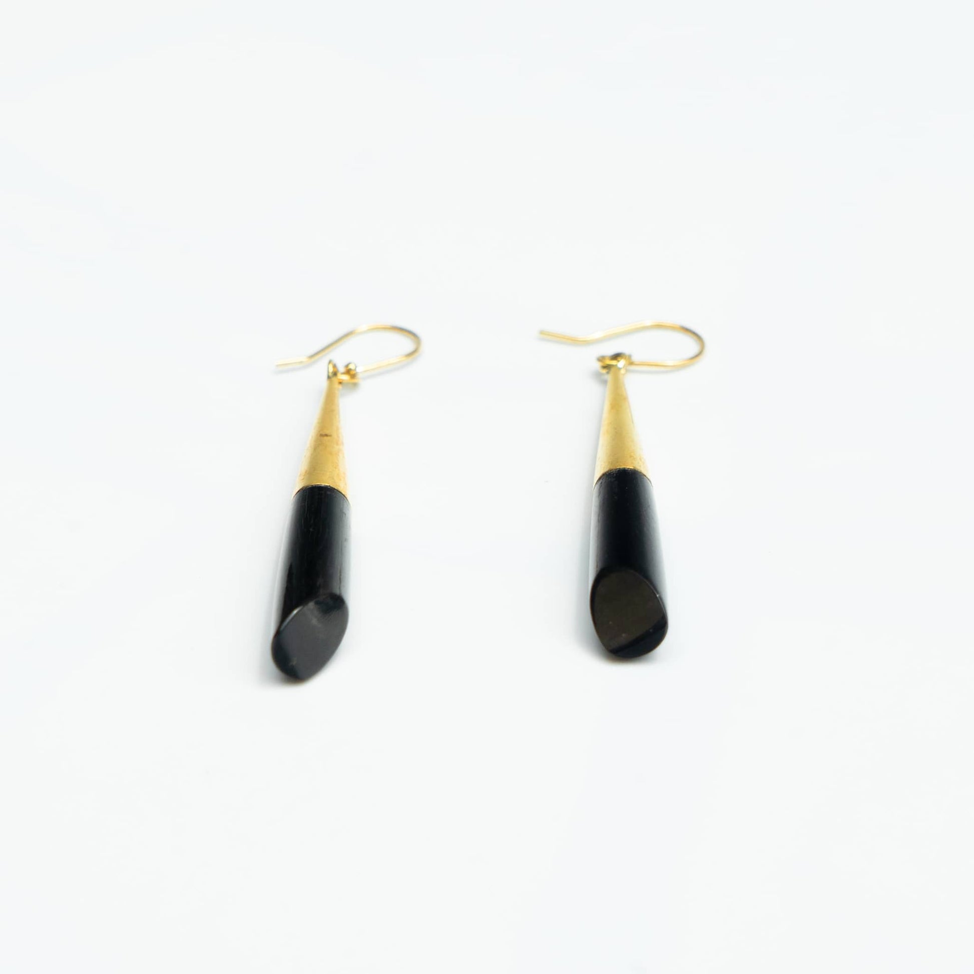 Shela black bone brass drop earrings worn showing material contrast