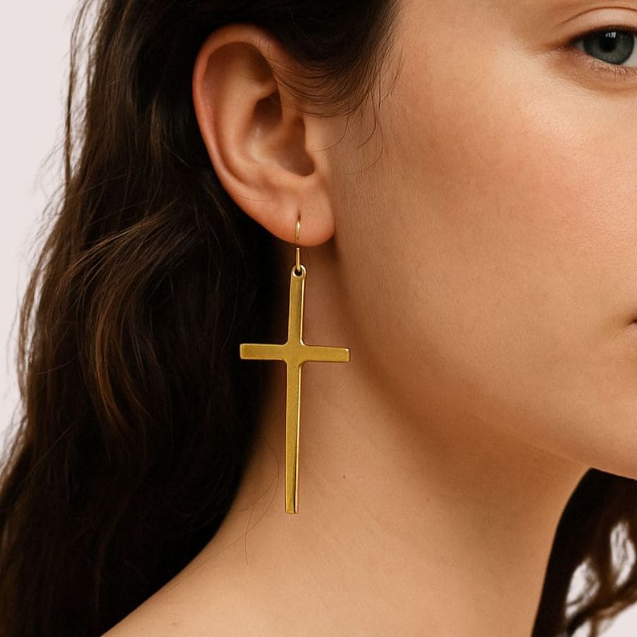 Smooth brass cross drop earrings worn on ear — Ecodunia