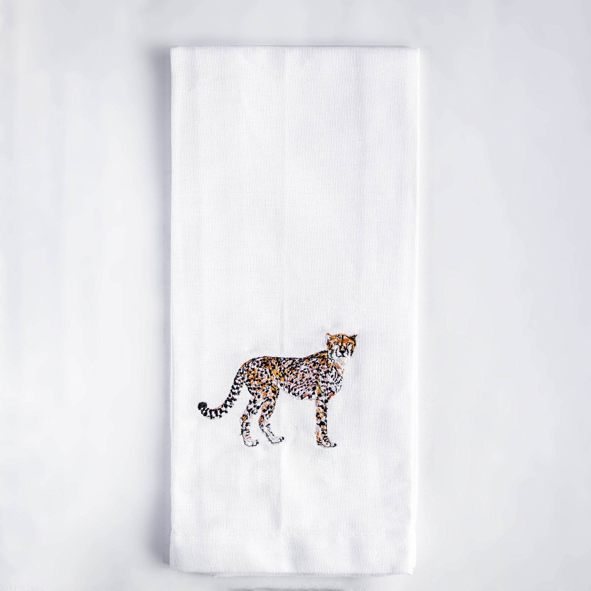 Cheetah embroidered cotton kitchen tea towel flat lay