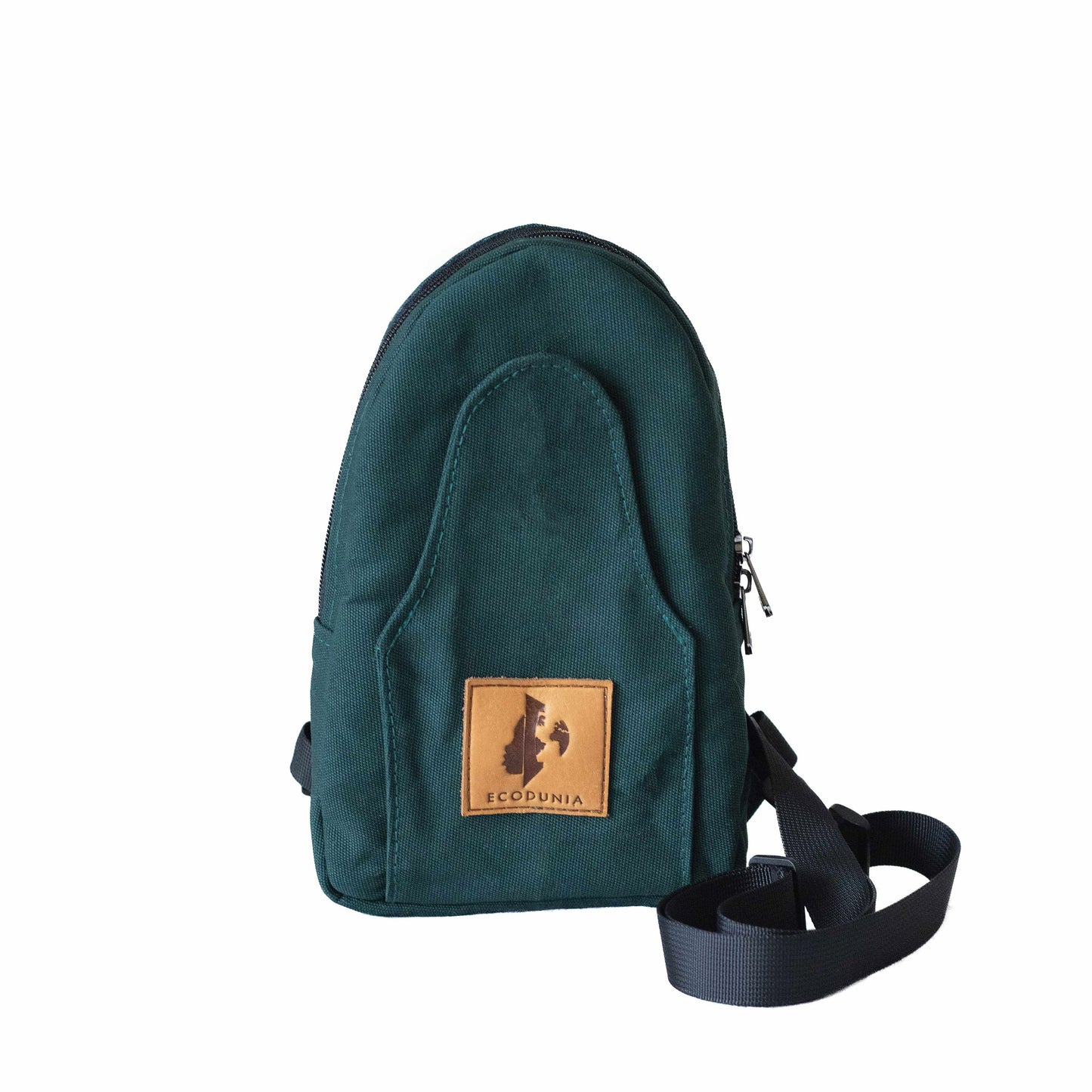 Buru canvas sling bag in forest green worn crossbody #color_forest-green