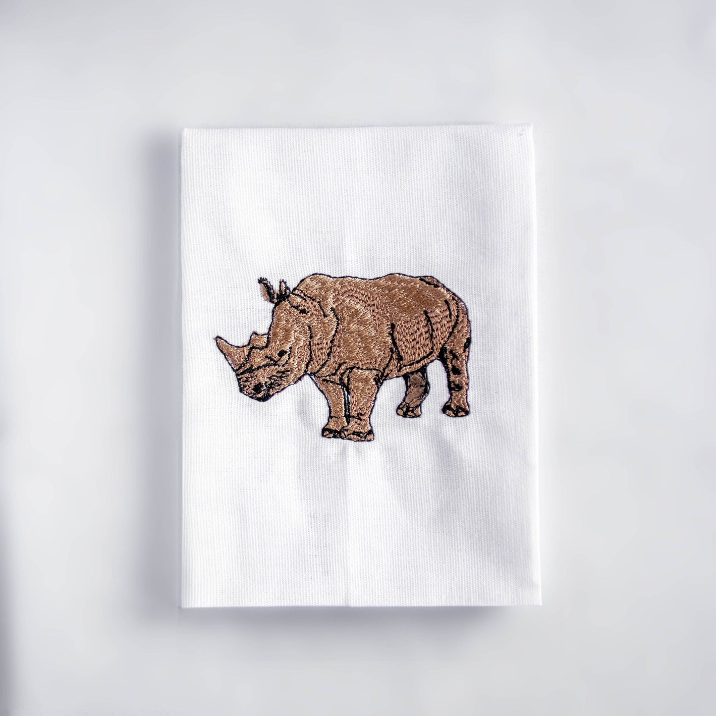 Rhino embroidered cotton cloth napkin on white background
