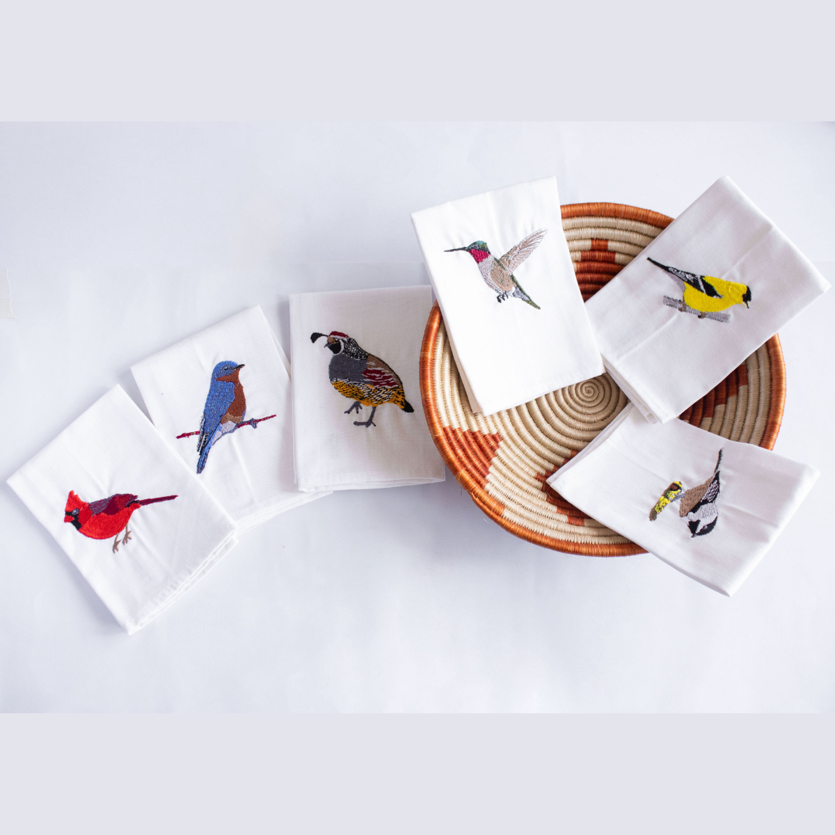 Ethically handmade bird embroidered cotton napkin on white