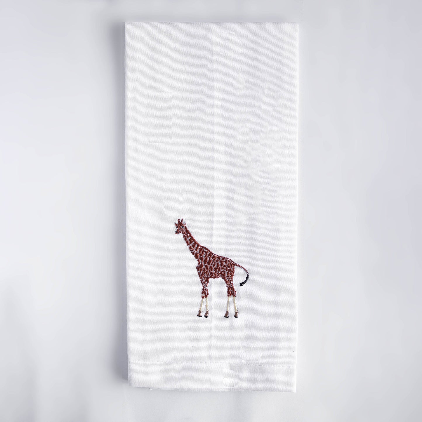 Giraffe embroidered cotton kitchen tea towel on white background