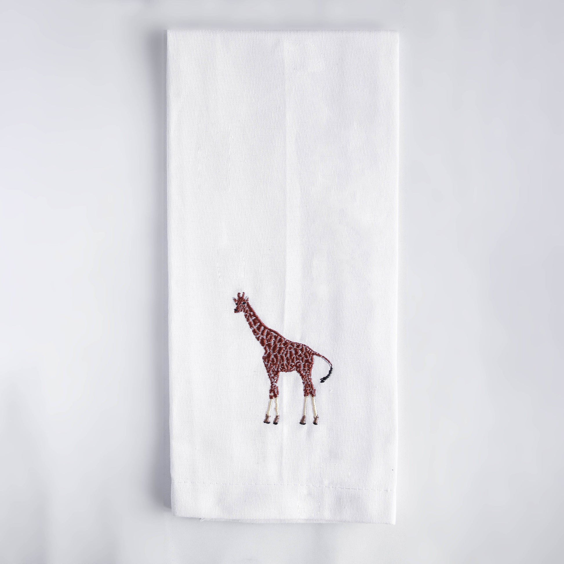 Giraffe embroidered cotton kitchen tea towel on white background