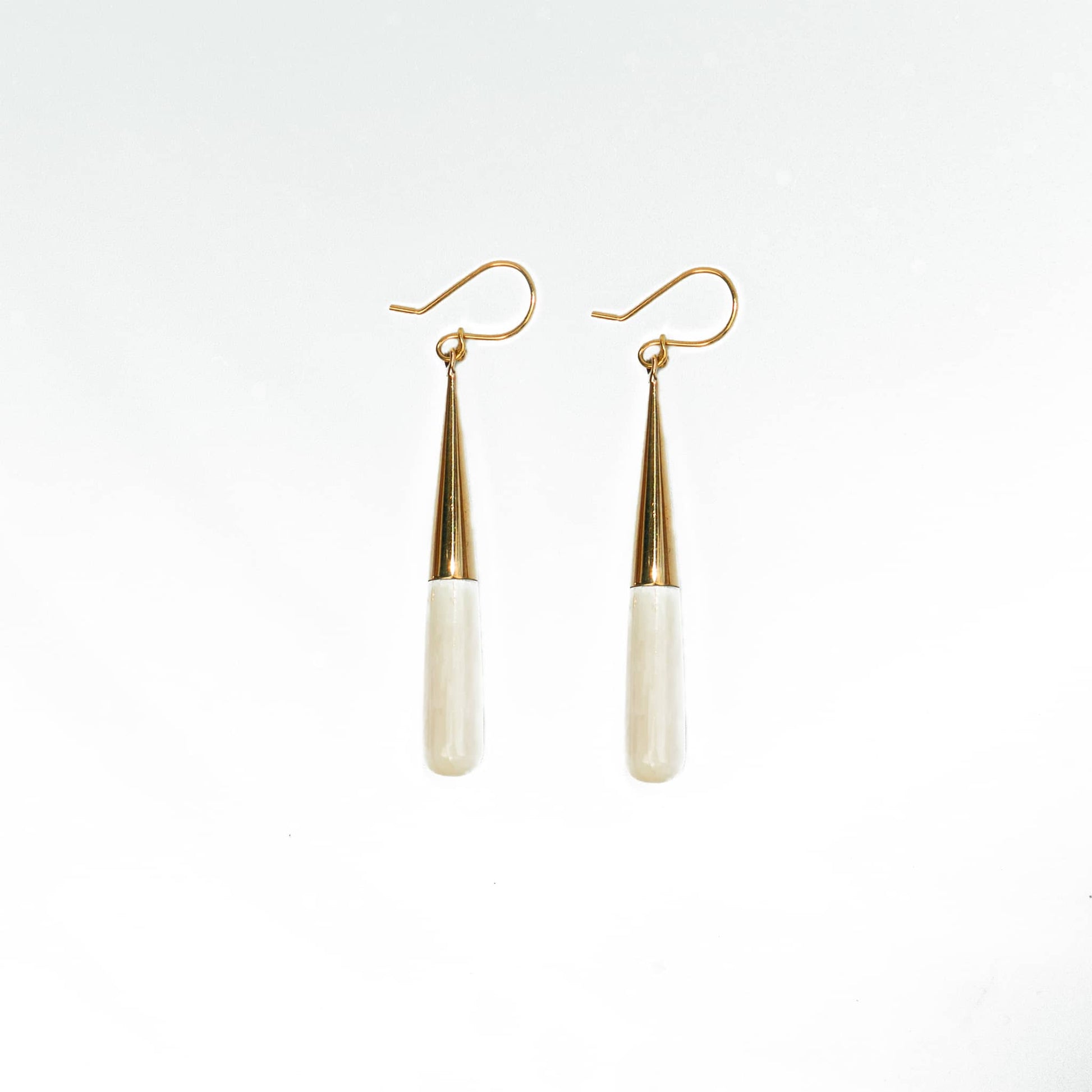 Guru brass and white horn teardrop earrings flat lay — Ecodunia